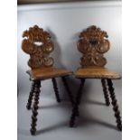 A Pair of Continental Carved Oak Hall Chairs with Barley Twist Legs and Carved Backs Featuring a