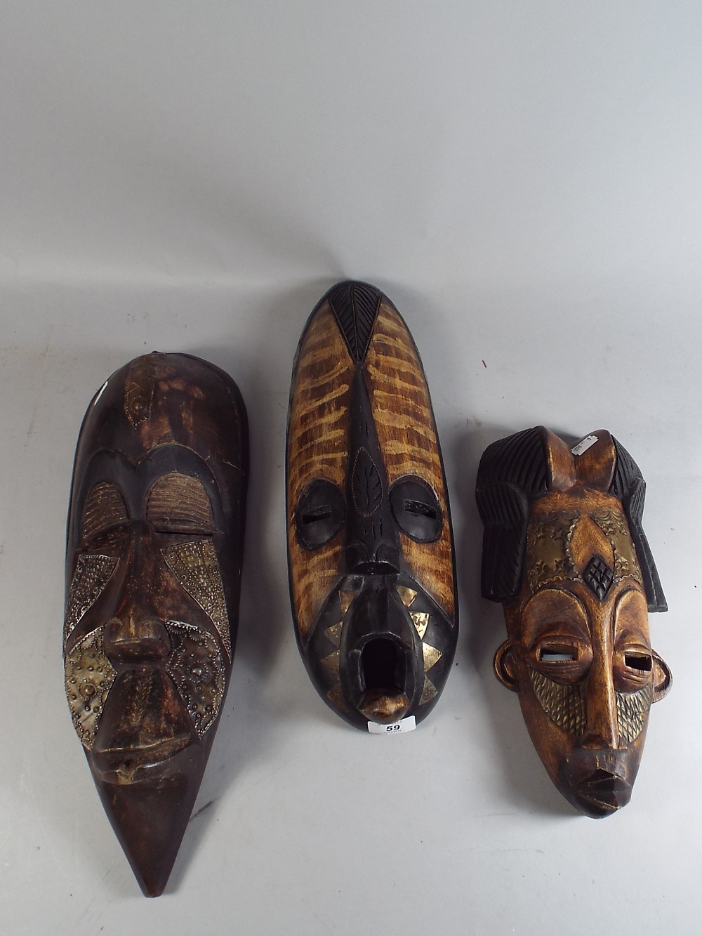 Three Carved Wooden Ethnic Masks.