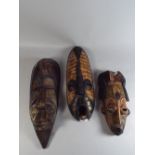 Three Carved Wooden Ethnic Masks.