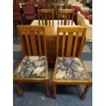 An Oak Drop Leaf Table and Bulbous Supports with Four Oak Dining Chairs.