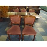 A Wooden Extending Dining Table with Two Pedestal Base with Five Dining Chairs.