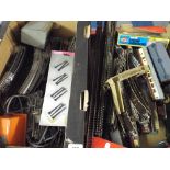 Two Boxes of  OO Gauge Train Track and Accessories to Include Train Station Controllers Etc.