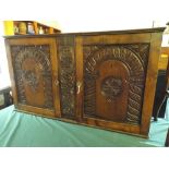 An Oak Wall Hanging Side Cabinet with Carved Doors.