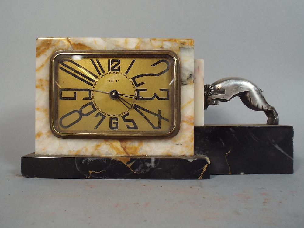 A French Art Deco Marble Mantle Clock with Chromed Ram Mount.