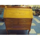 A Light Oak Bureau with One Long and Four Short Drawers on Cabriole Legs with Raised Gallery Back.