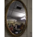 A Gilt Framed Oval Wall Mirror.