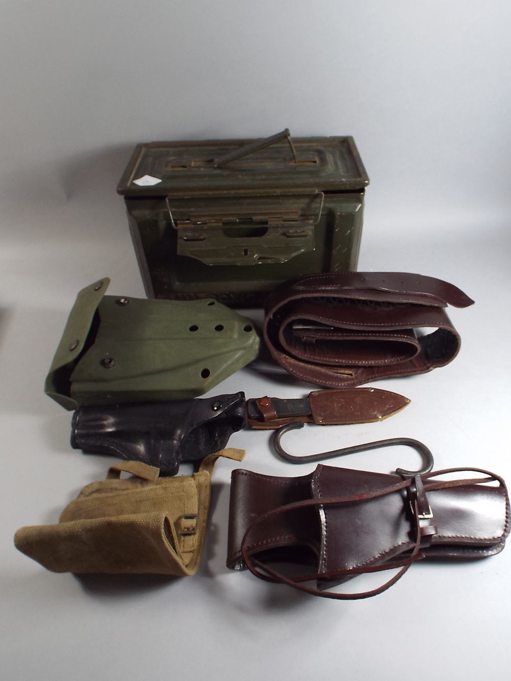 A Fifty Cal Ammunition Box Containing 1984 Dated Entrenching Tool, Modern Gun Holster and Belt,