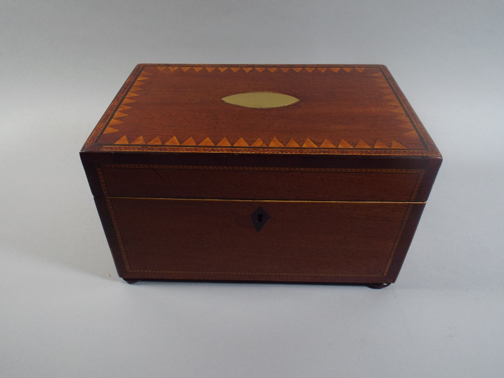 An Inlaid Mahogany Work Box with Oval Brass Escutcheon and Brass Lion Mask Ring Handles.