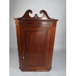 A Late 19th Century Walnut Corner Cabinet with Crossbanded Panelled Door to Three Shaped Shelves.