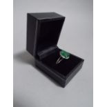 A 14K White Gold and Diamond Ring set with an Oval Cut Emerald Approx 4ct. Diamonds Approx 0.