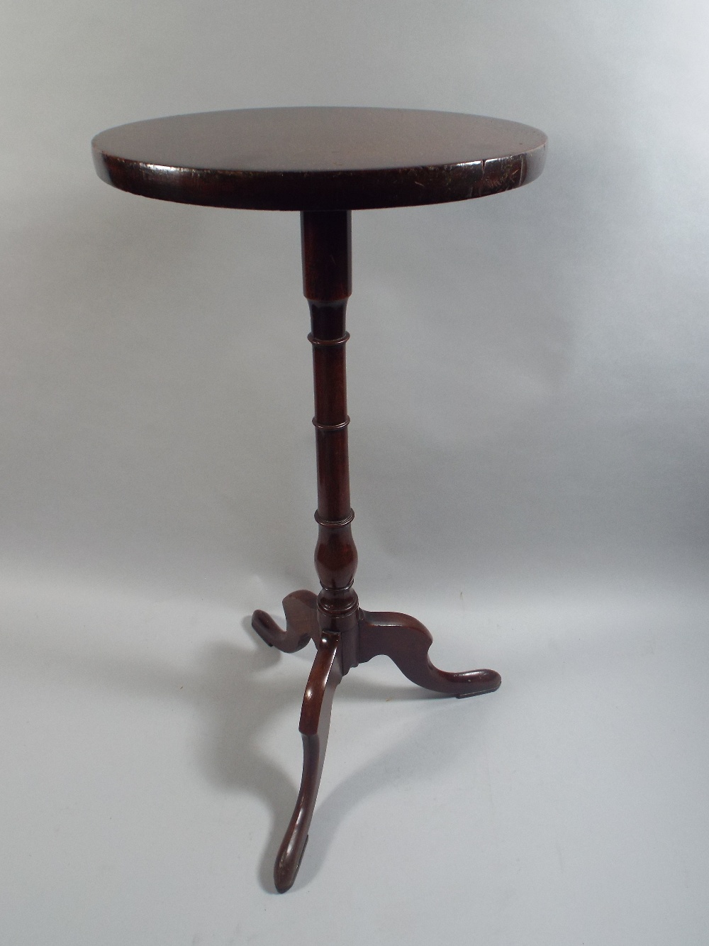 A George III Mahogany Kettle Stand with a Solid Top over Turned Stem and Tripod Base.