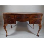 An Edwardian Crossbanded Burr Walnut Ladies Writing Desk of Serpentine Form.