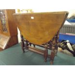 An Oak Drop Leaf Gate Leg Table on Turned Supports