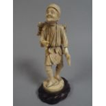 An Early 20th Century Ivory Okimono Figure of an Elderly Wood Cutter Holding an Axe and Pipe.