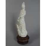 A 19th Century Chinese Blanc De Chine Figure of Guanyin, Mounted on a Turned Wooden Base.
