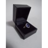 A 14K White Gold and Diamond Ring Set with an Oval Cut Blue Sapphire, Approx 3ct. Diamonds Approx 0.