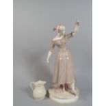 A Continental Cold Painted Porcelain Figure of a Maiden with Castanets and a Belleek Cream Jug.