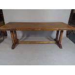 An Oak Refectory Style Dining Table with Carved Side Panels Depicting Fish, Loaves,