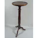 A Turned Mahogany Tripod Torchere Stand.