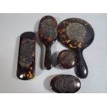 An Art Deco Japanese Tortoiseshell Five Piece Dressing Table Set Carved and Pierced with Dragon