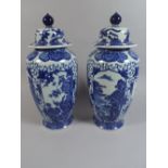 A Pair of Transfer Printed Blue and White Oriental Vases and Covers. 40.