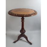 A Victorian Walnut Tripod Wine Table with Carved Circular Border to Top and Turned Suppport.