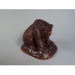 A 19th Century Black Forest Carved Linden Wood Bear resting on His Haunches.