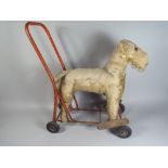 An Early 20th Century Lines Brothers, Ireland, Ride On Mohair Toy Dog.
