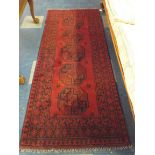 A Handmade Afghan Rug on Red Ground 1.92x0.