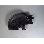 A 19th Century Irish Bog Oak Pin Tray in the Shape of a Pig. Carved with Shamrock and Harp Detail.