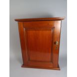 A 19th Century Mahogany Hanging Wall Cupboard with a Fielded Paned Door and Brass Fittings.