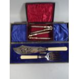 A Cased Set of Bone Handled Fish Servers and A Pair of Nut Crackers.