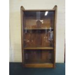 A Glazed Shelved Bookcase.