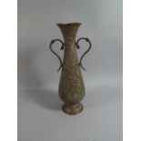 An Indian Brass Two Handled Vase with Embossed and Engraved Decoration.