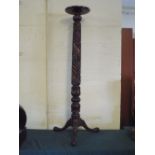 A Carved Mahogany Torchere Stand on Tripod Base 133 Cm High.