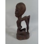 A Carved Ethnic Grotesque Study of A Tribal Figure 31 Cm High.