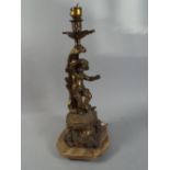 A French Brass and Onyx Figural Table Lamp Depicting Dancing Cherub.