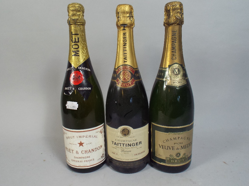 Three Bottles of Champagne Moet, Taittinger and Veuve de Medts.