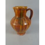 A Slip Ware Glazed Terracotta Jug.