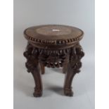 An Oriental Carved Padouk Wood Marble Top Stand with Claw and Ball Feet.