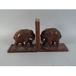 A Pair of Carved Wooden Bookends in The Form of Elephants.