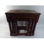 An Edwardian Oak Nest of Three Tables with Bobbin Supports.