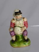 A Miniature Porcelain Figure depicting a man enjoying a pint, est height 9 cms (1).