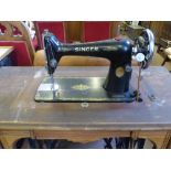 A vintage Singer sewing machine on a Jones treadle base.