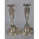 A Pair of Continental Silver Candlesticks, with central tri-footed support with classical masks, est