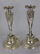 A Pair of Continental Silver Candlesticks, with central tri-footed support with classical masks, est