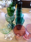 Fourteen pieces of coloured glass comprising six various wine, six tumblers and two black vases.