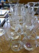 Six glass jugs, some having cut design and some having floral patterns together with Seven pieces of