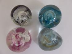 Four Scottish Caithness Paperweight, of the crystal series, blue, black and white, lilac and pink.