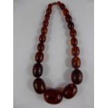 Set of Graduated Oval Amber Beads, the centre bead measures 3 x 2.2 cms, approx 40 cms in length.